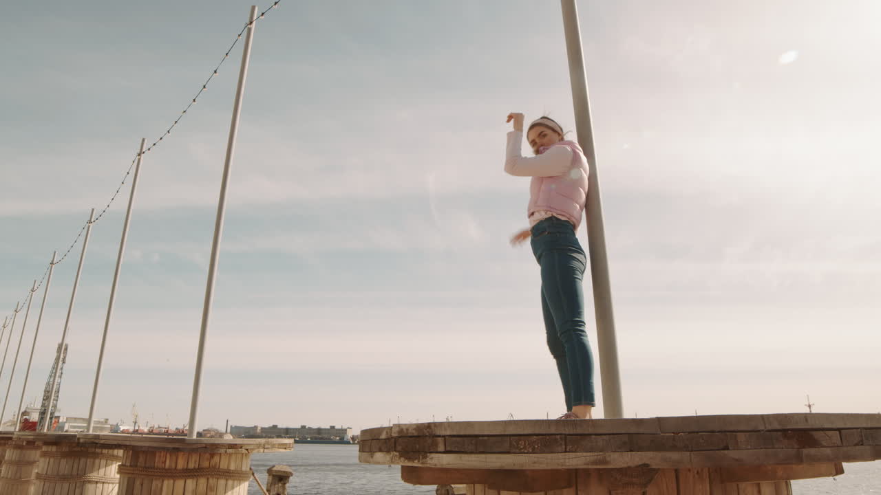 Young Woman Dancing by Pillar Outdoors