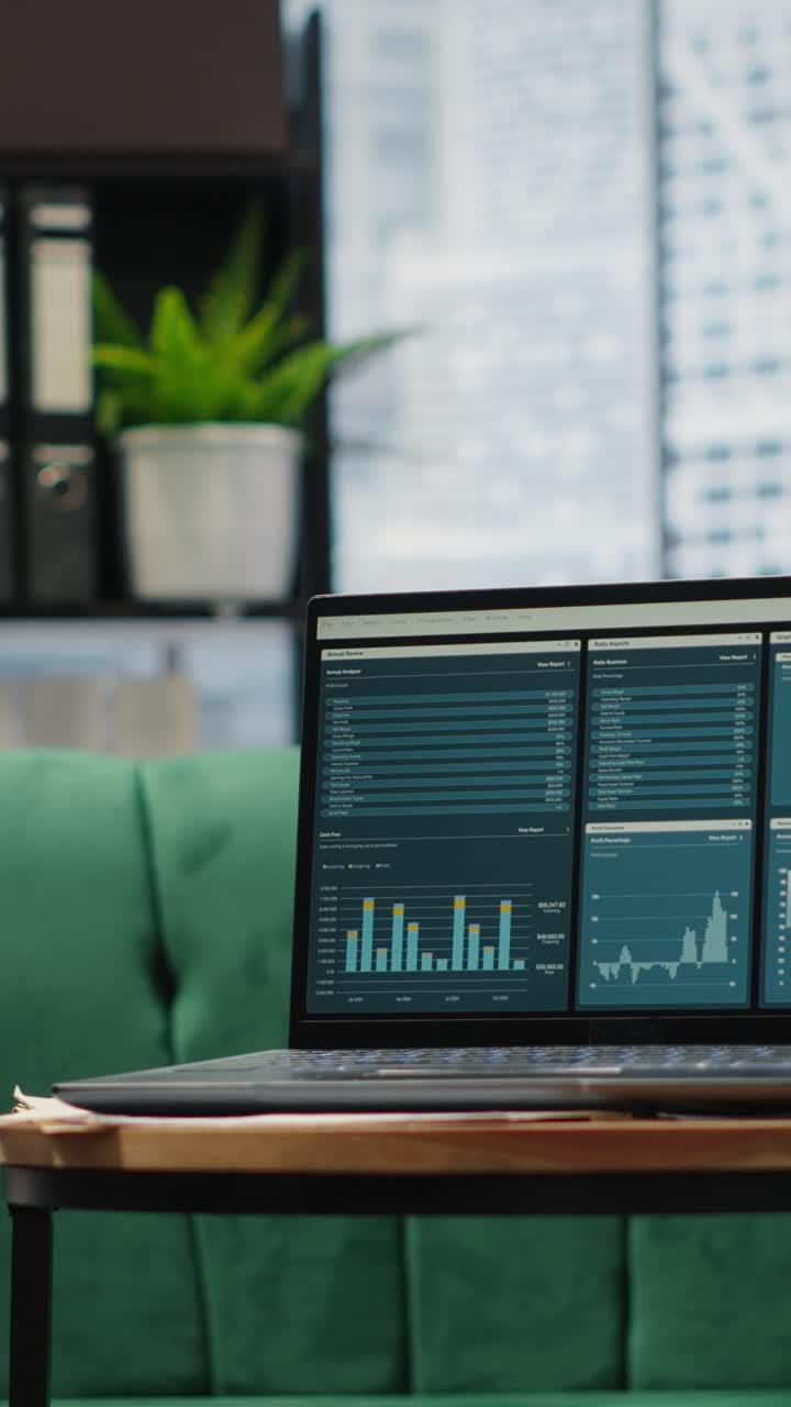 Vertical Video Modern high end empty office space with a laptop running infographics