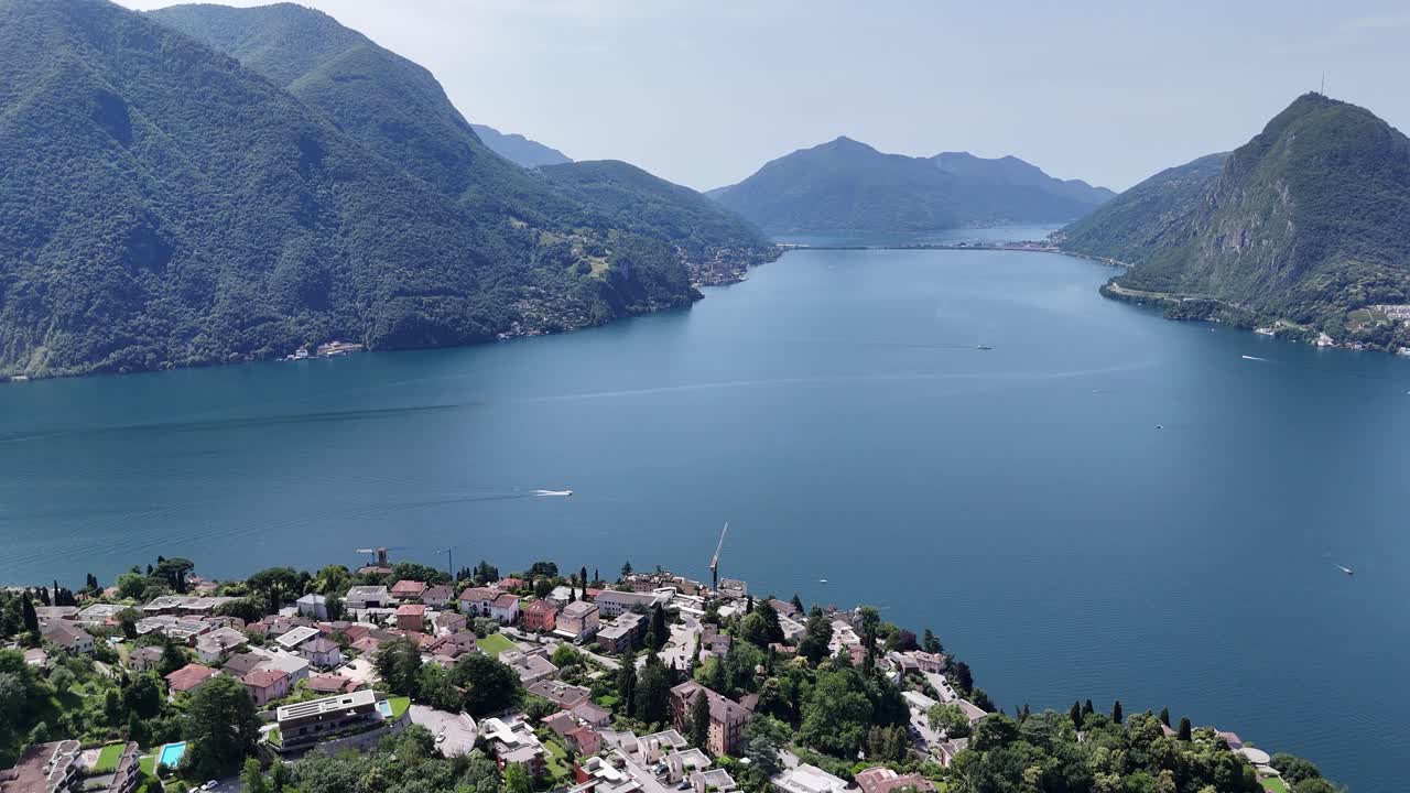 Blue water of Lake Lugano Switzerland high angle drone,aerial 4K footage