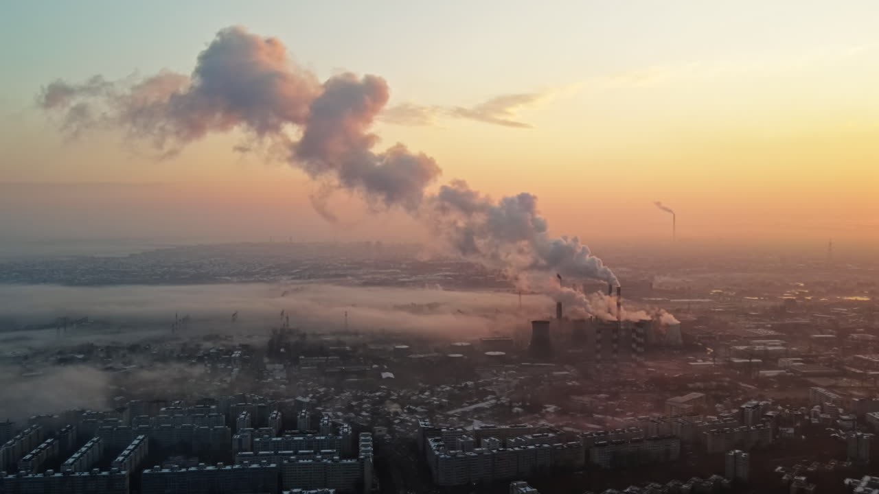 Cityscape of Bucharest from a drone, rows of residential buildings, thermal station with fog getting out and other the ground, ecology idea, Romania