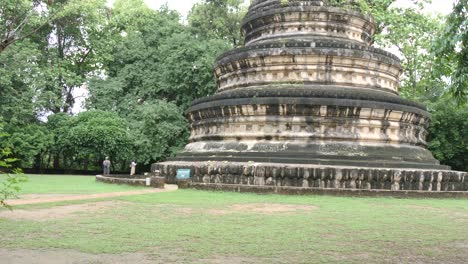 Ancient stupa in Wat Umong temple, surrounded by lush green trees in Chiang Mai
