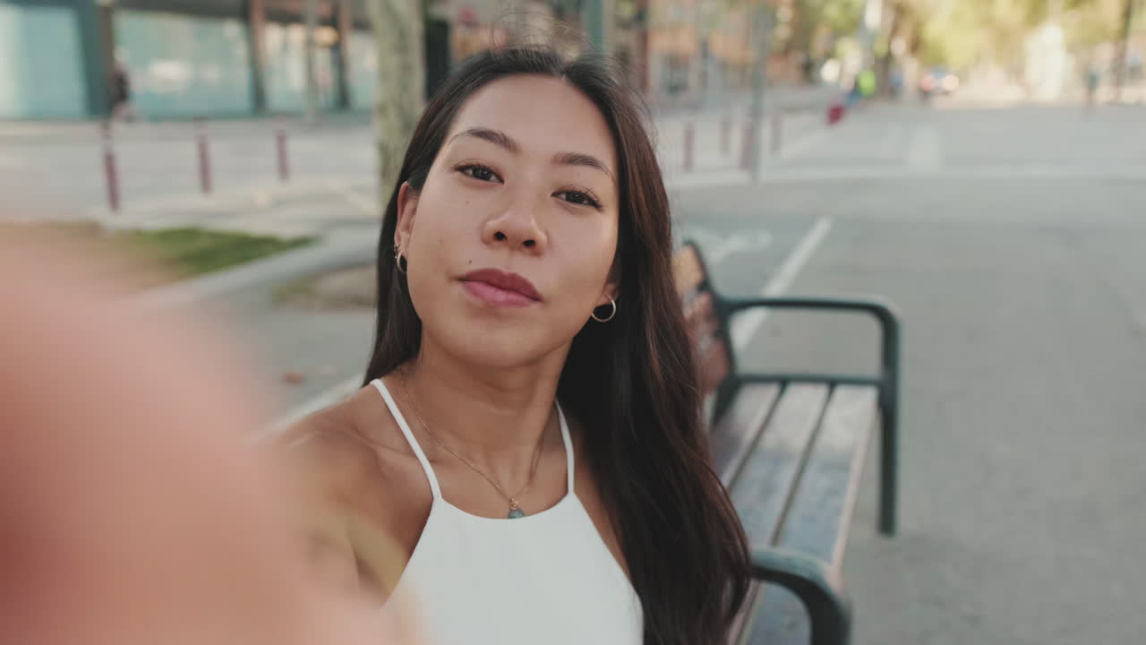Woman takes a selfie on a city street