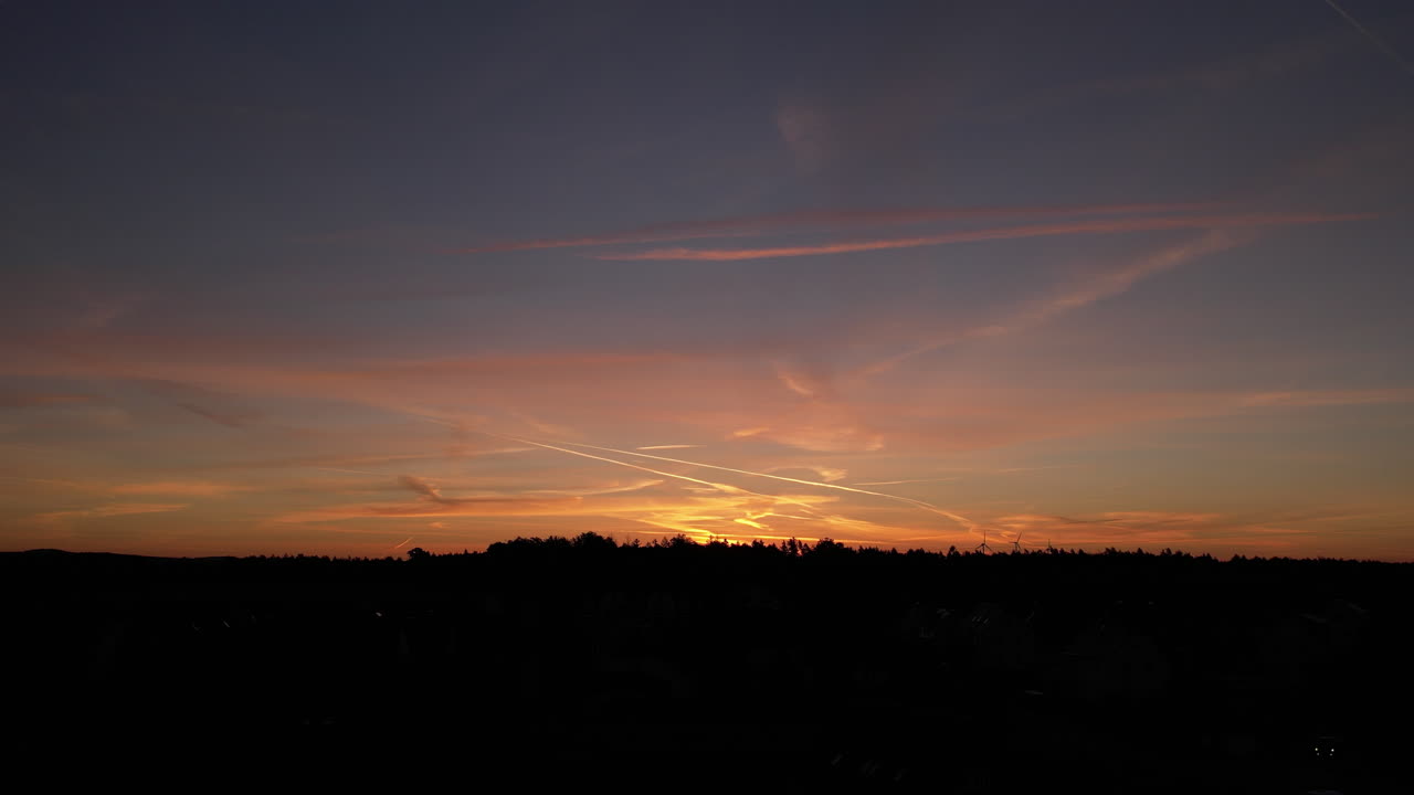 Sunset over a small village in Germany - Saxony - wind turbines in background