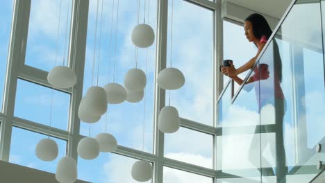 woman standing at balcony and having cup of coffee 4k