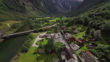 beautiful village in green valley surrounded by mountains in næroyfjord area in norway, fjord scenery