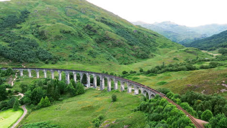 establishing drone shot of glenfinnan viaduct during the day at glenfinnan, in the lochaber district of north-western scotland, uk