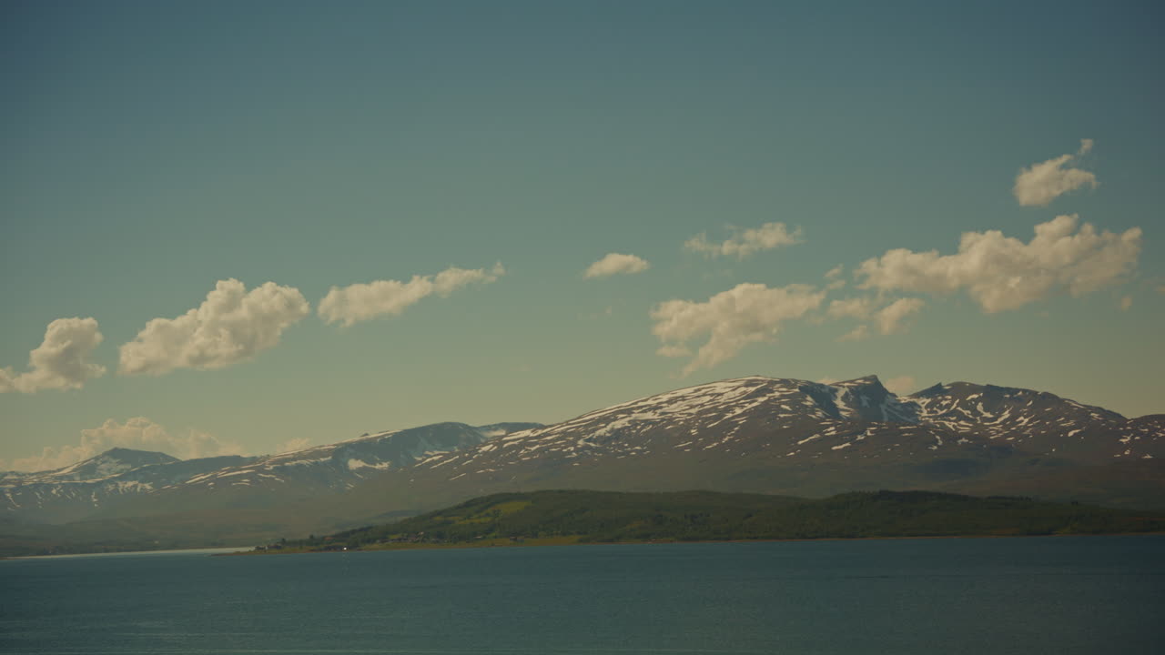 Timelapse of the Norwegian Fjords at sunset in the Lofoten Islands, Norway. View of the traveling clouds and the picturesque nordic landscape.