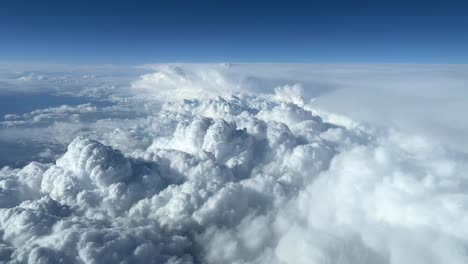 Aerial view taken from a jet cockpit of some huge cumuloninbus during cruise level during daylight