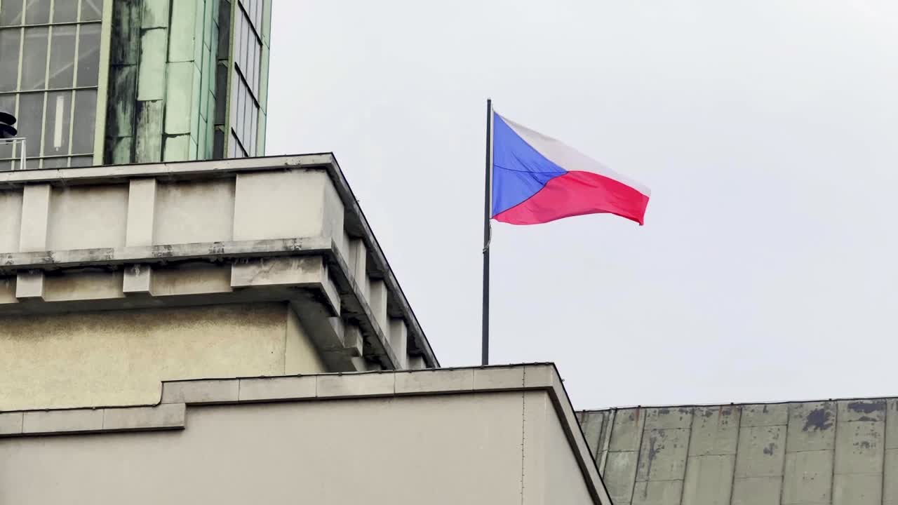 Czech flag waving in wind on building in Ostrava, slow motion
