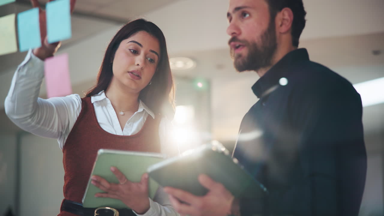 Business Team Planning and Discussing Strategy with Sticky Notes and Tablets