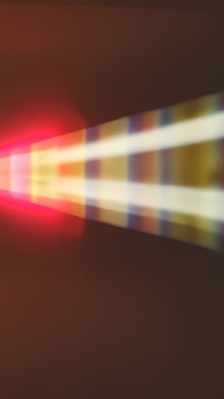 Vertical video: Flaring apex driving triangle beam sliding wall with white stripe, bands, red glows