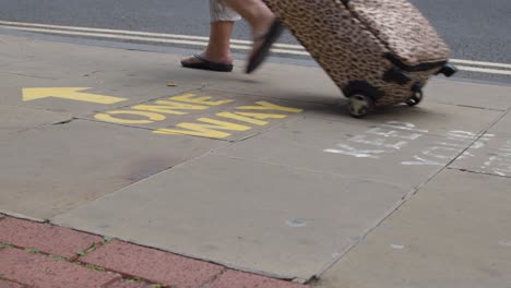 close up shot of feet walking over one way pavement marking in oxford england