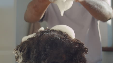 little african american boy enjoying bathing with dad