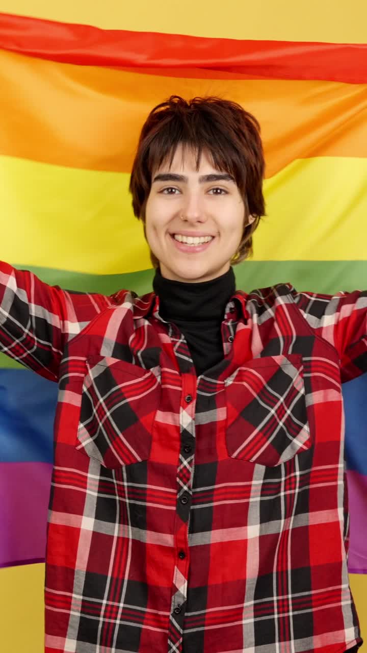 Person proudly holding a rainbow flag