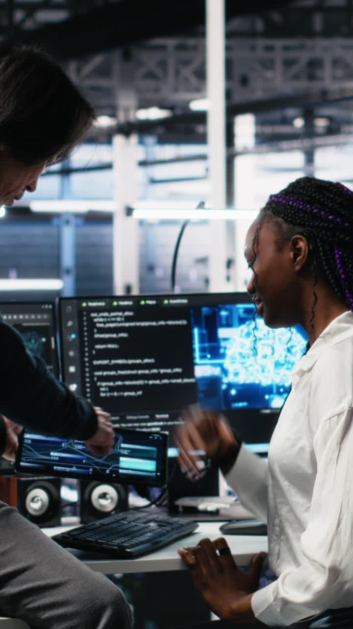 Vertical video Senior engineer and trainee in data center working on neural networks