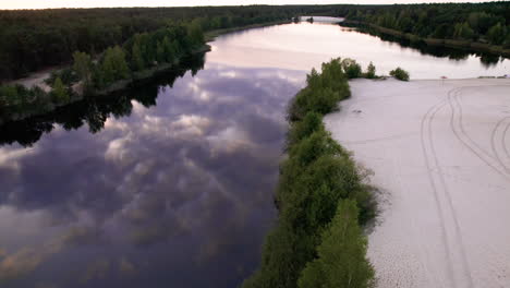 aerial view of big river near the dunes and forest