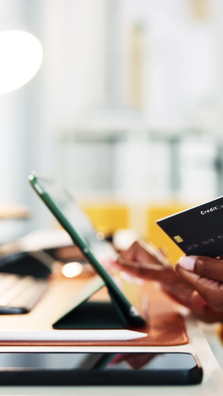 Person Making Online Purchase with Credit Card on Tablet