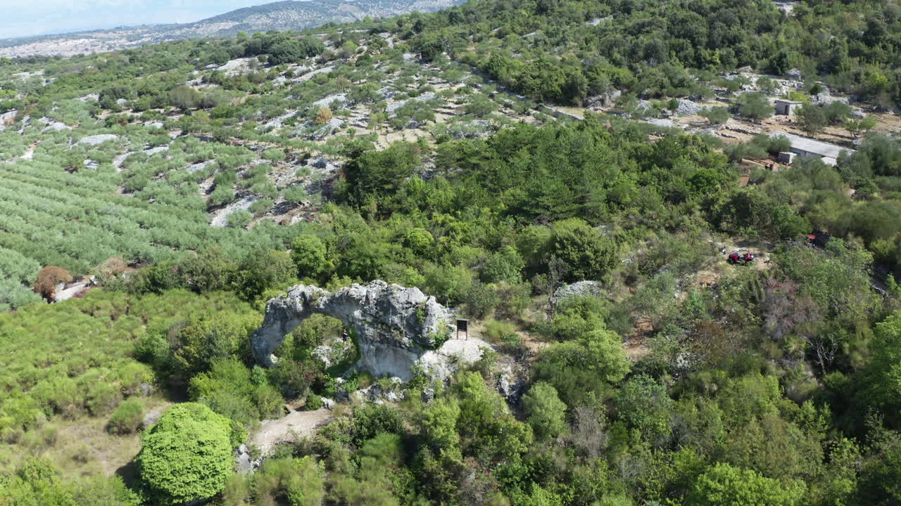 Flyover Aerial of Koloc Arch, Formed by Two Arches and Wind Erosion, Brac Island, Croatia