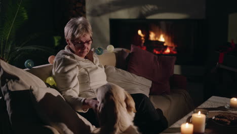 senior woman and dog by the fireplace