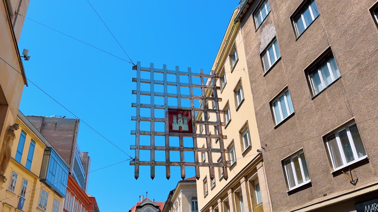 Laurinc Gate hanging among the buildings. Low angle view at the former part of the defensive wall of old town in Bratislava, Slovakia