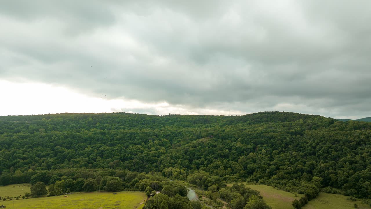 Cloudscape Over Thicket Forest With A Bridge And Flowing River In Lancaster, Arkansas, USA