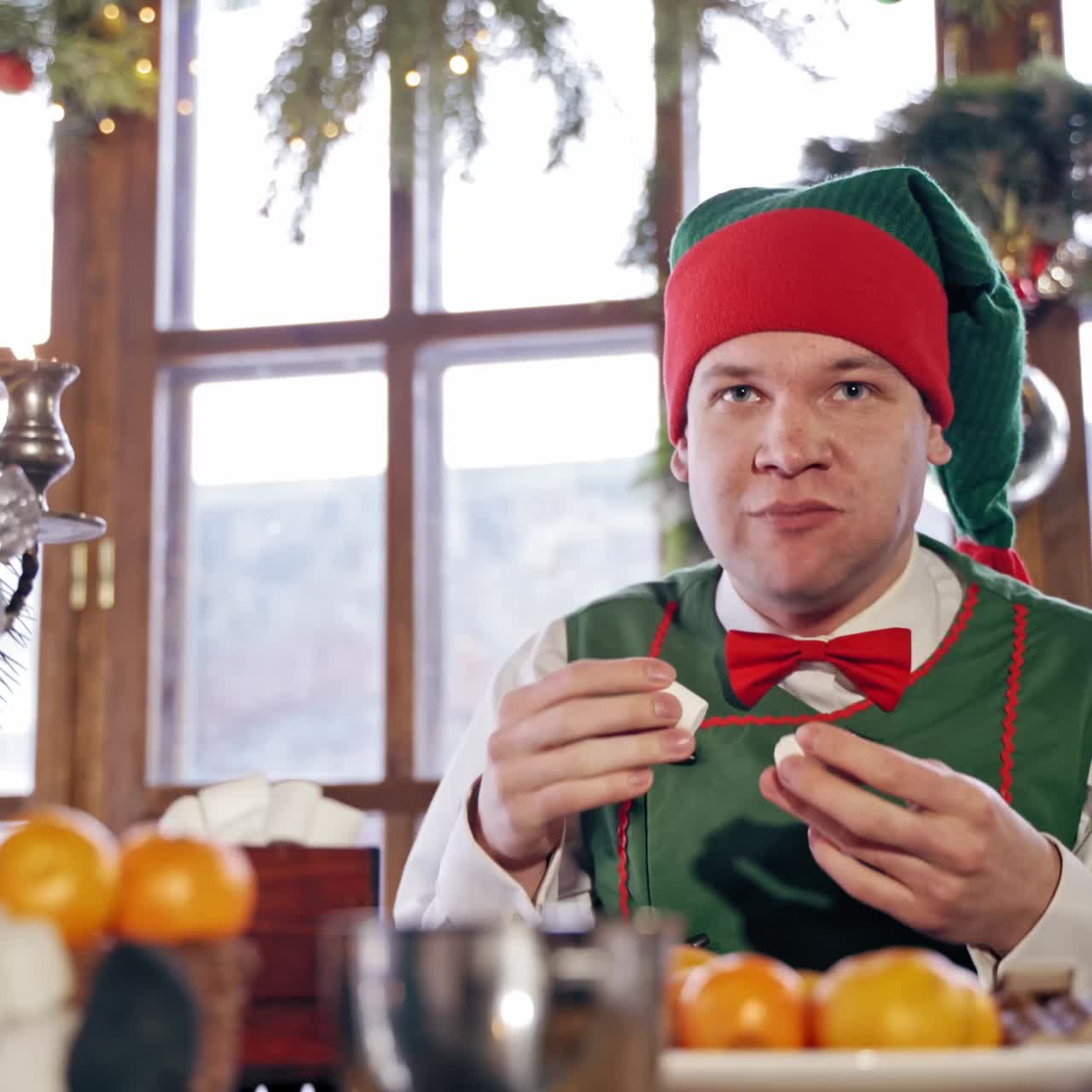 Male elf eating sweets