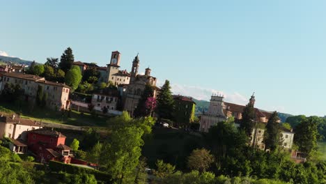 drone orbiting above neive medieval town in cuneo province, italy. aerial shot
