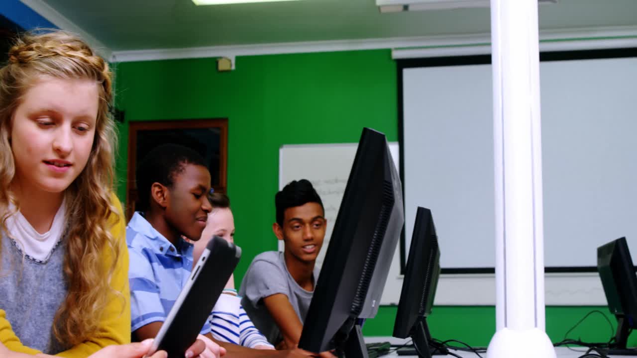 Students studying on computer in classroom