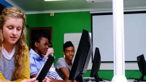 students studying on computer in classroom