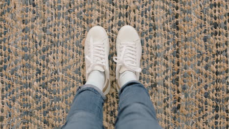 top view woman wearing white shoes enjoying stylish new footware standing on carpet rug