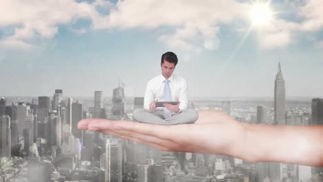 Hand-holding-sitting-businessman-focused-on-tablet-computer-above-skyscrapers