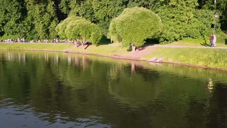 park scene with people and water reflection