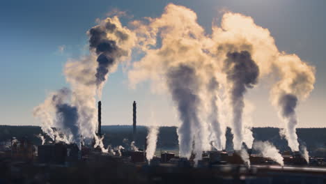 ugly sight of factory chimneys causing air pollution by emitting gases, aerial