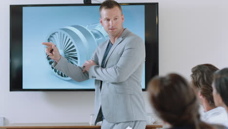 business people meeting in boardroom engineer man presenting turbine design on tv screen sharing technical briefing with colleagues discussing ideas in office presentation