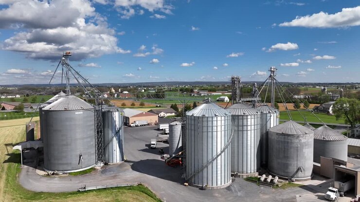 Rising drone shot showing silos at stone quarry factory in american countryside
