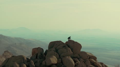 Lone-hiker-crossing-steep-cliffs-atop-a-mountain