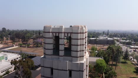 close-up aerial parallax panning shot of the landmark tower at eliot arts magnet academy that survived the eaton fire in altadena, california. 4k