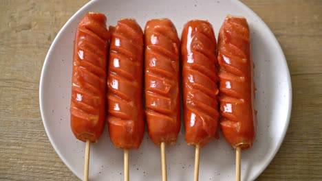 fried sausage skewer on white plate