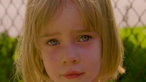 outdoor portrait of an adorable blue-eyed little girl