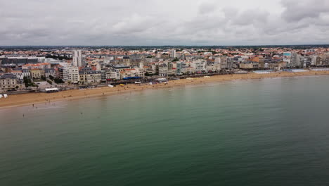 Saint-Malo-beach-and-shoreline,-France.-Aerial-backward