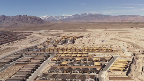 new homes in las vegas nevada. snow-capped mt charleston in distance. drone backwards 4k