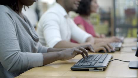 closeup shot of people working with computers at tables