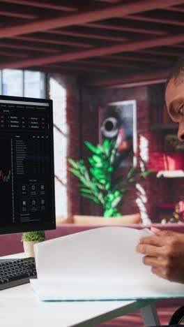 vertical video african american man using pc to purchase and sell stocks