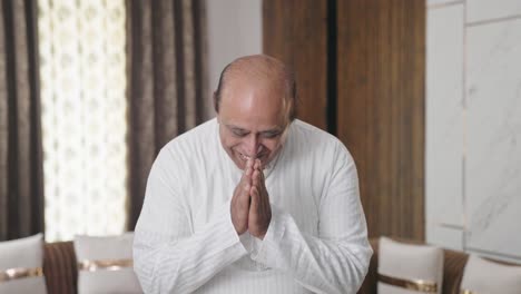 indian old man doing namaste and greetings