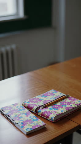 notebooks on a wooden desk