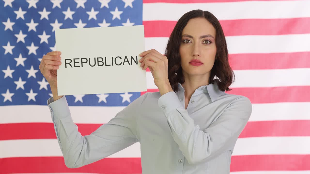 Woman holding sign that says republican in front of American flag