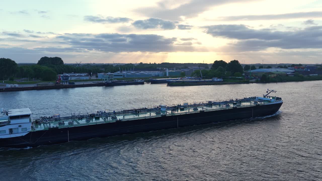 Oil Tanker Ship Sailing Along River Waterway, Aerial Tracking Side View