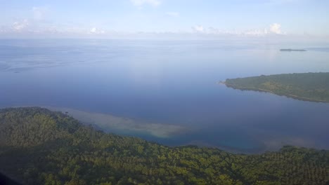 flying over remote tree covered tropical islands and stunning ocean in small aeroplane on wild travel adventure in the wilderness