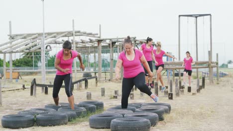 Female-friends-enjoying-exercising-at-boot-camp-together