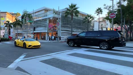 lamborghini sports car crossing intersection at rodeo drive in beverly hills, slow motion shot.
